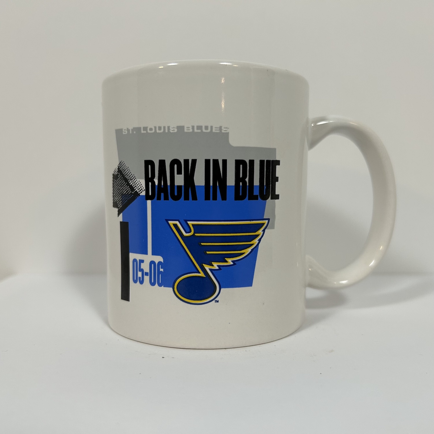 white coffee mug with Blues logo and the slogan Back In Blue