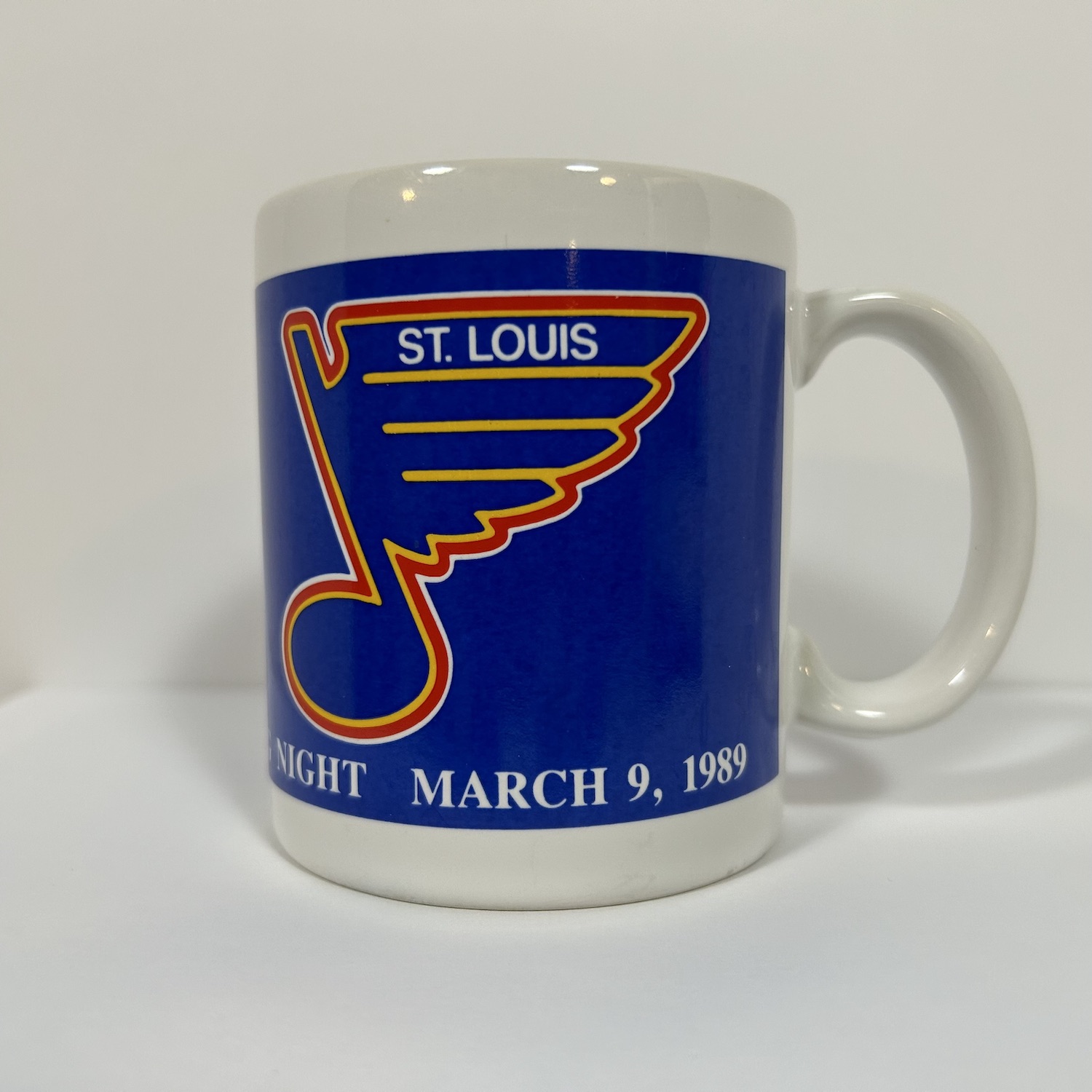 vintage white coffee mug with vintage blue, white and red St. Louis Blues Logo on front