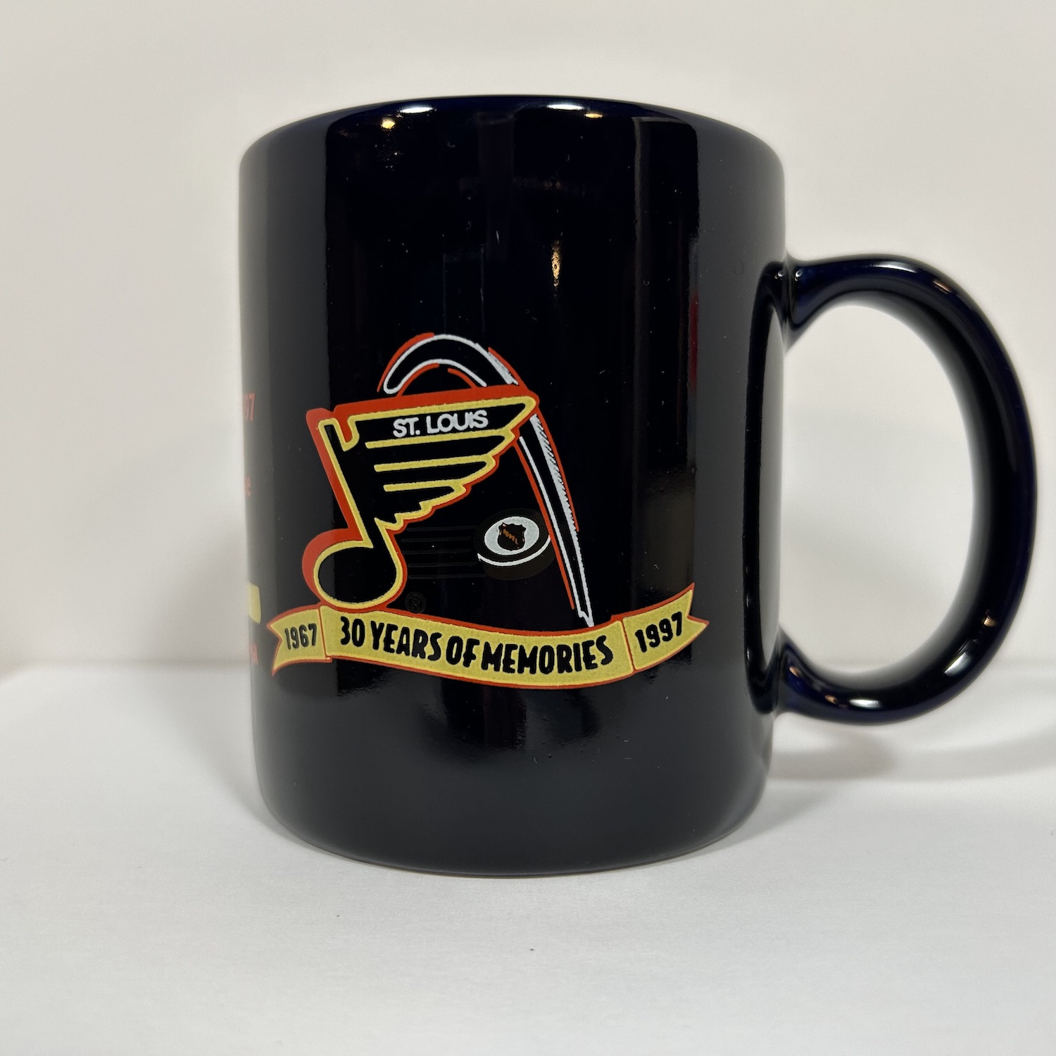 Dark navy coffee mug with st. louis arch and retro blues logo