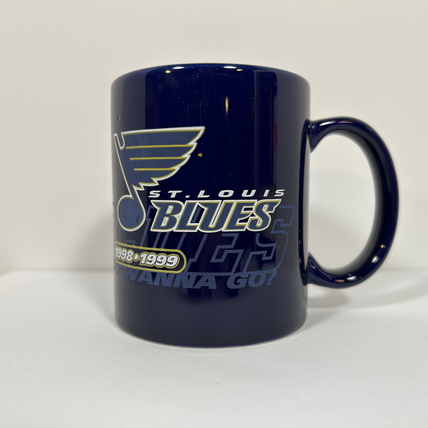 Navy coffee mug with Blues logo on top of the phrase You Wanna Go